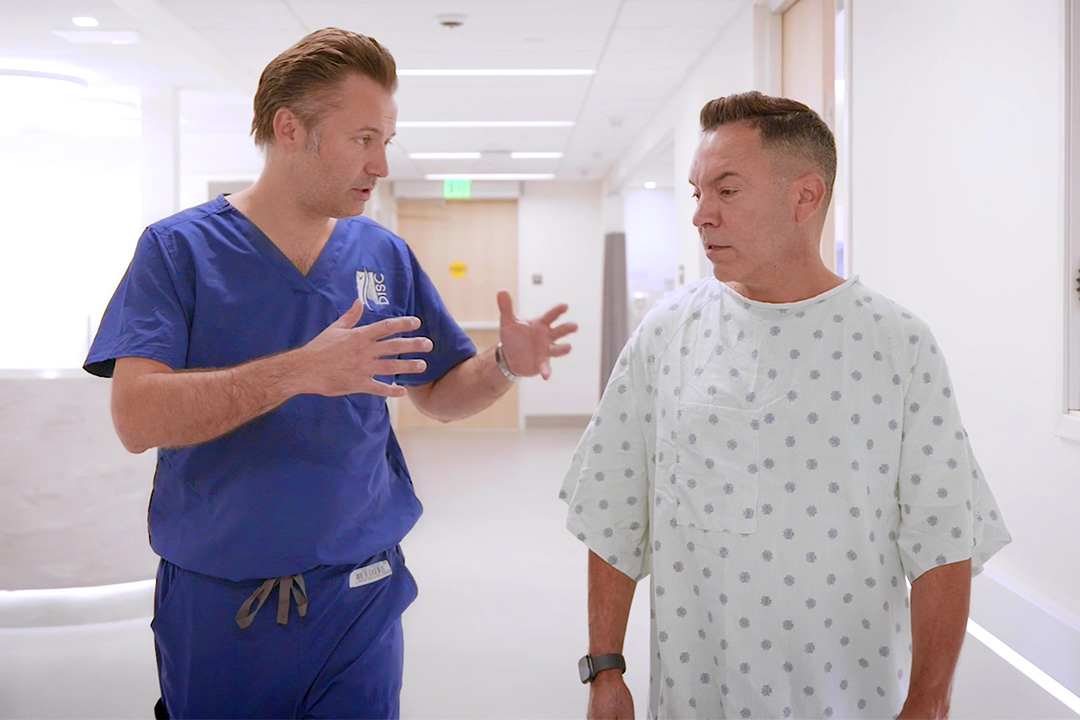 Dr. Luke Macyszyn talking with patient