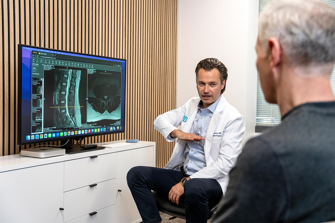Dr. Luke Macyszyn explaining procedure to patient