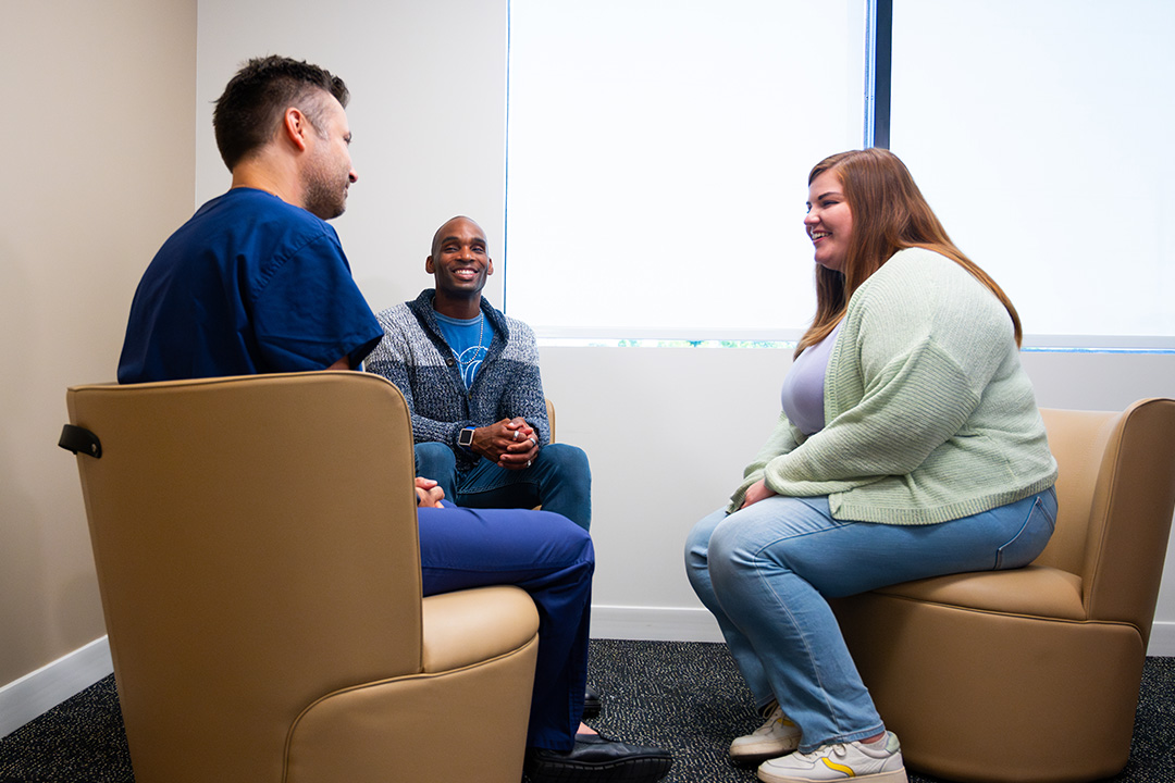 Dr. Luke Macyszyn talking with patient