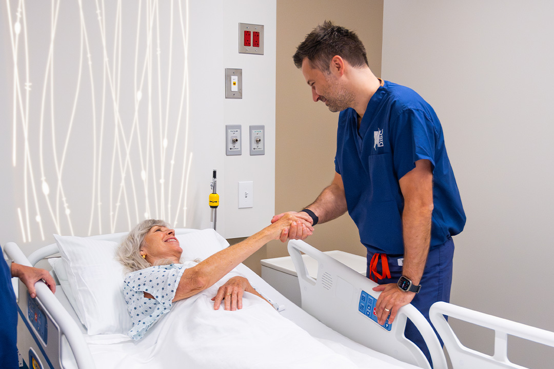 Dr. Luke Macyszyn talking with patient