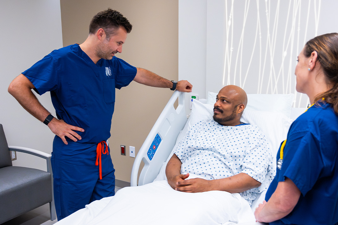 Dr. Luke Macyszyn speaking with patient