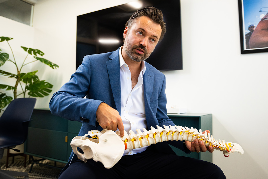 Dr. Luke Macyszyn using spine model