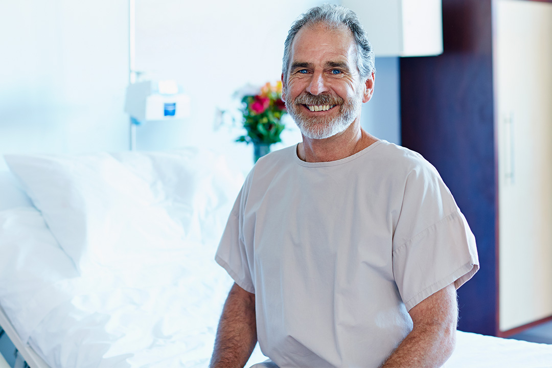 mature-male-patient-smiling-pre-surgery