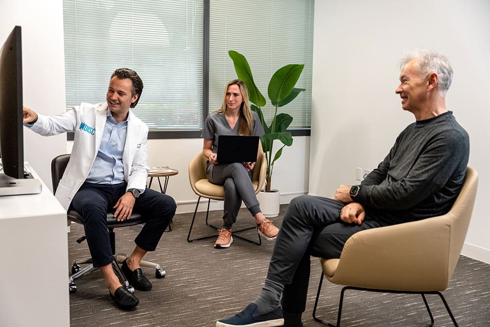 Dr. Macyszyn consulting with patients at Encino location