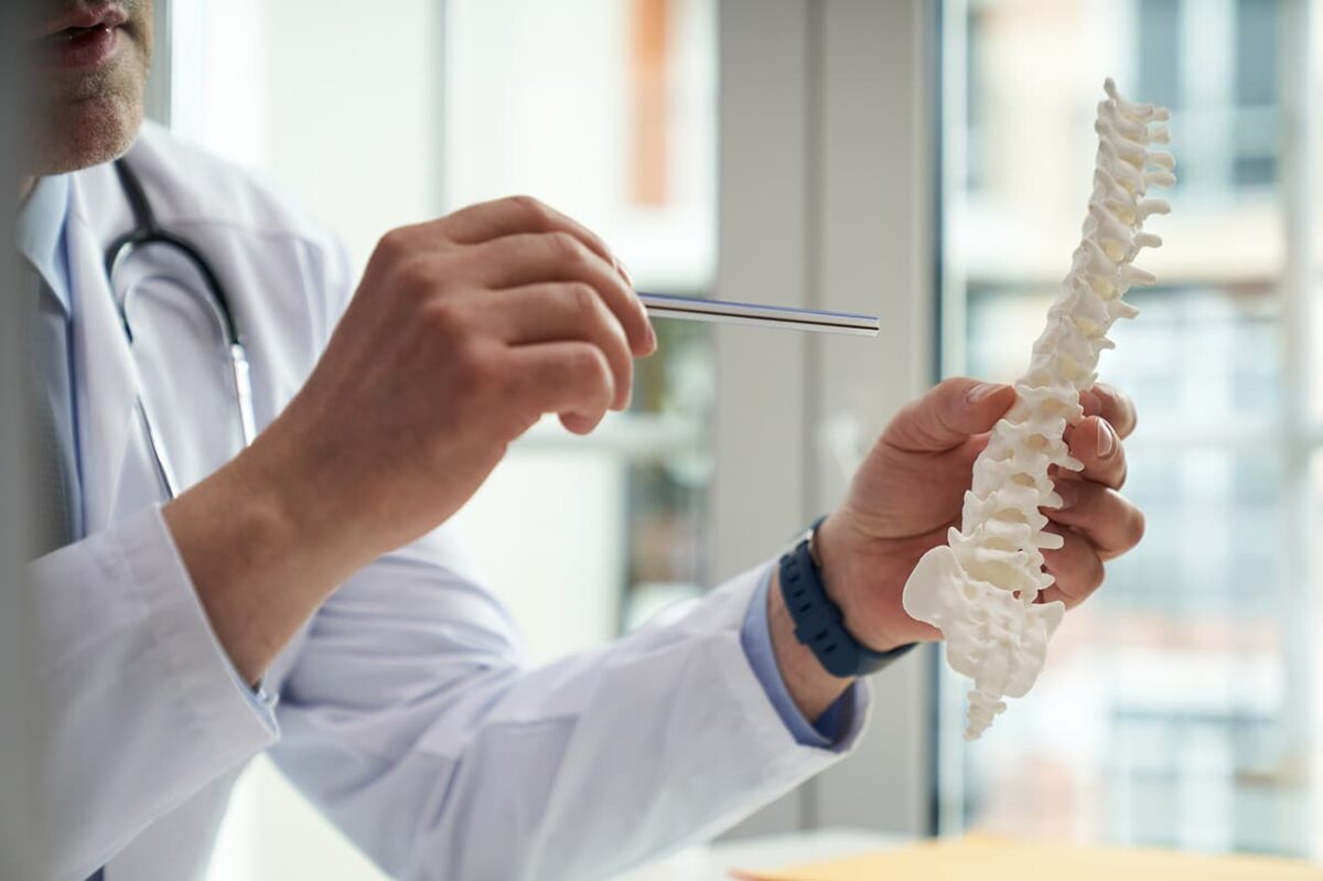 Doctor pointing to spine diagram