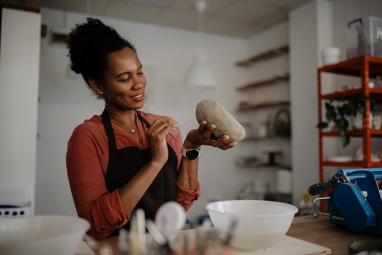 woman creating pottery