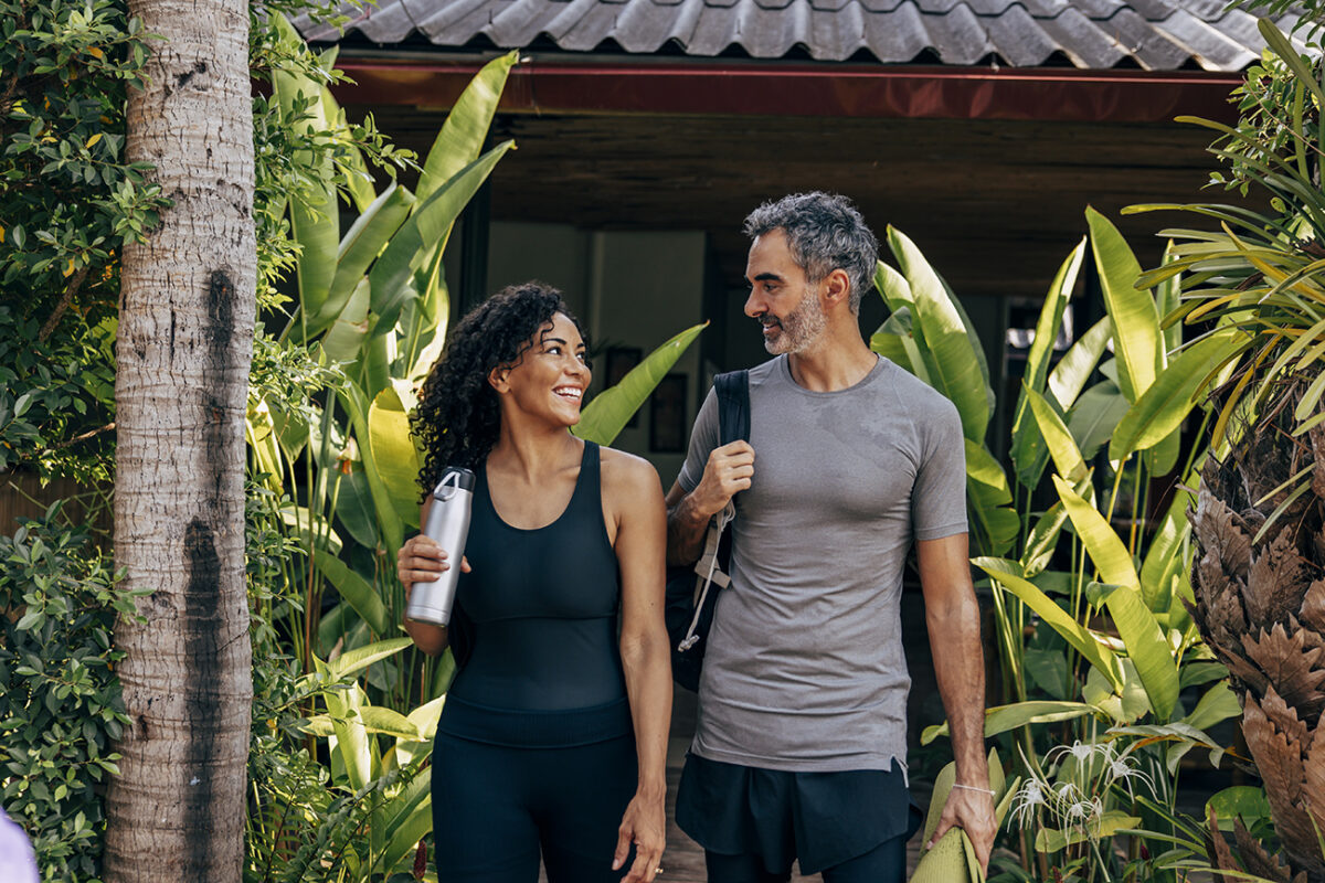 smiling woman and man leaving yoga session