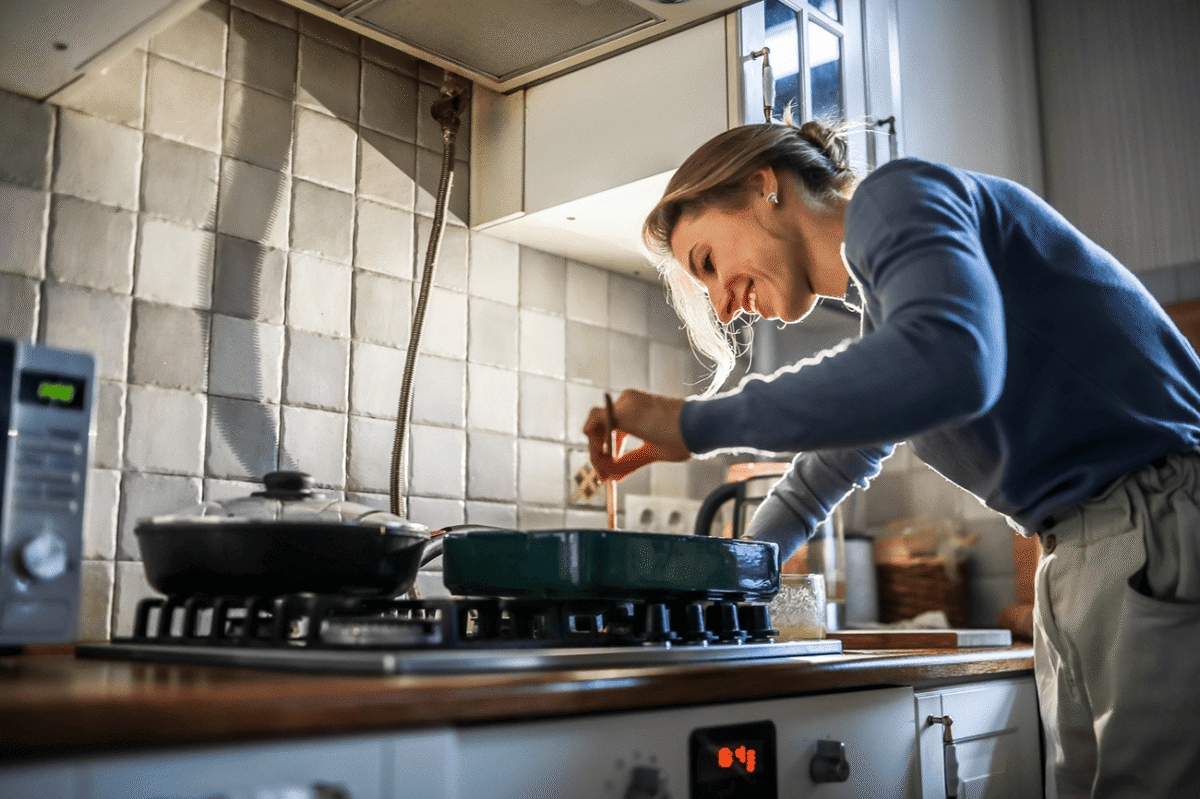 Woman cooking over stove